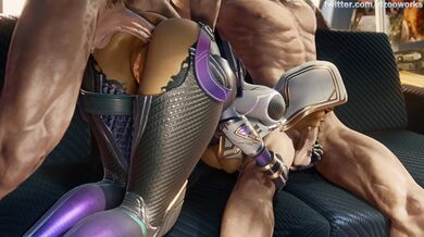 'Busty Vixen Strips Naked, Rubs Her Juicy Lips on Two Hard Cocks While Laying Down on a Luxurious Bed'