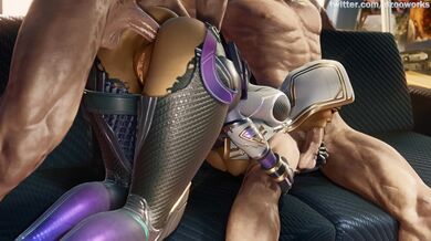 'Busty Vixen Strips Naked, Rubs Her Juicy Lips on Two Hard Cocks While Laying Down on a Luxurious Bed'